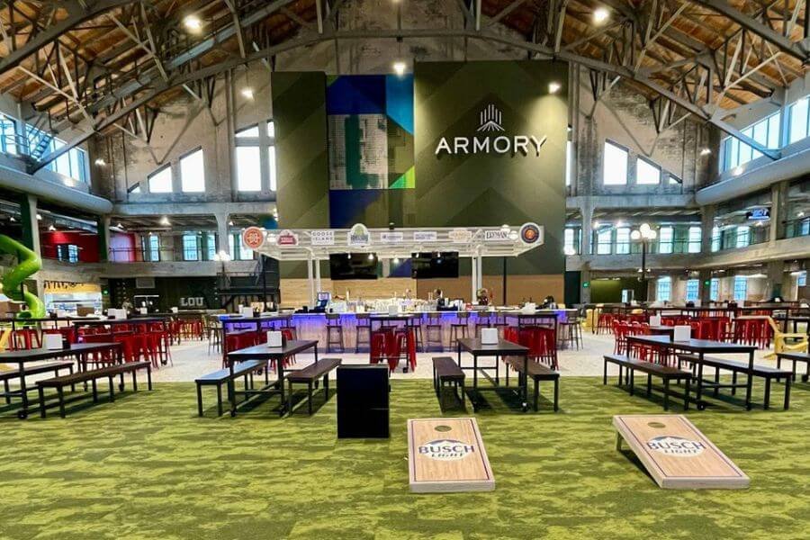 A captivating view of the expansive interior of The Armory, a grand multi-venue entertainment destination in St. Louis, filled with vibrant lights, stylish decor, and a bustling atmosphere.